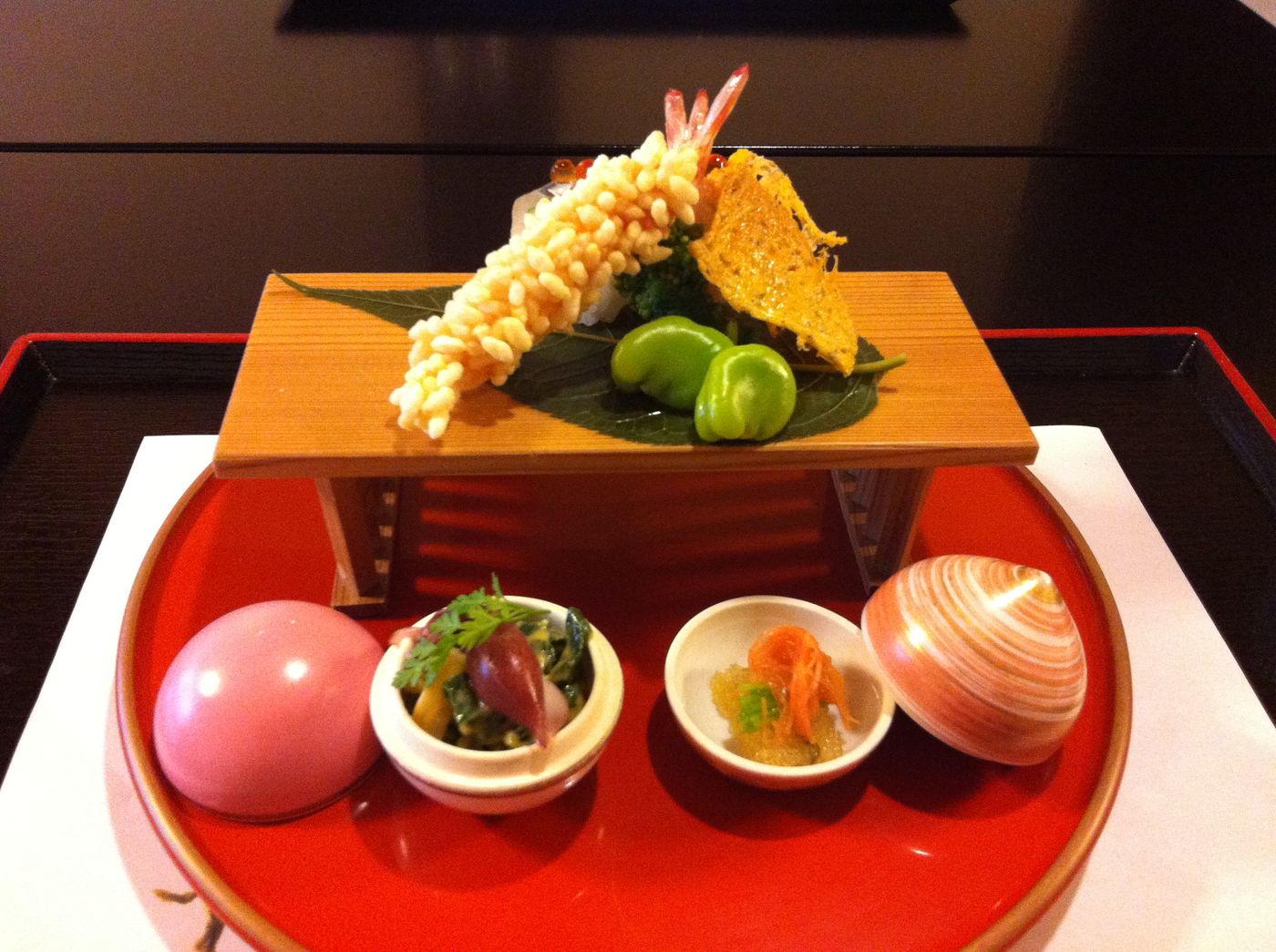 Seasonal kaiseki dinner dishes arranged on lacquer trays