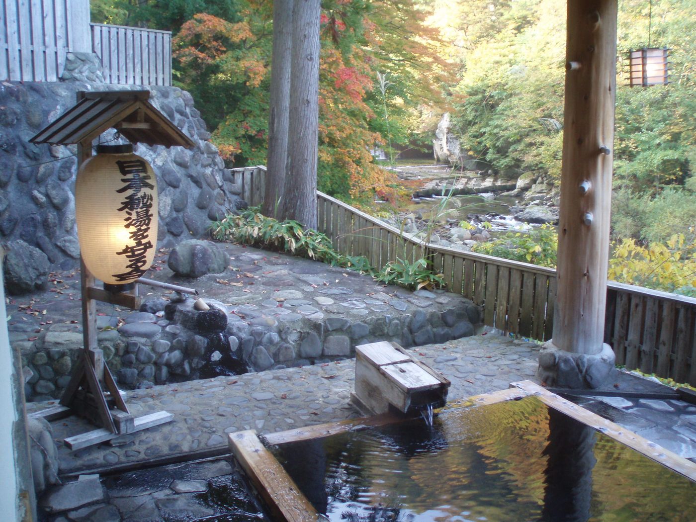 Outdoor rotenburo hot spring bath surrounded by nature